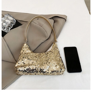 Detailed view of the sparkling gold sequined hobo bag on a neutral fabric background