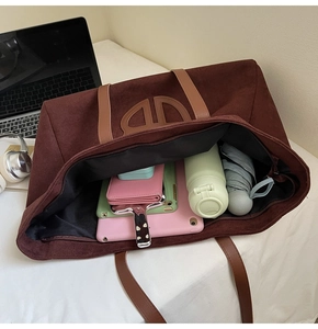 Top view of large brown suede tote bag showing interior storage for tablets and daily items
