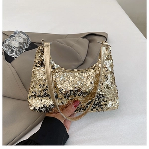 Detailed view of shimmering gold sequins on a half-moon evening bag with metallic handle