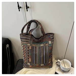Detailed view of woven ethnic tote bag with colorful geometric patterns and fabric texture