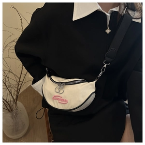 Detail of off-white crescent canvas bag with pink FANKISSA logo and black strap