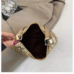 Detailed top view showing gold sequin bag interior with zipper and smooth brown lining
