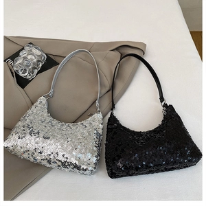 Detail of silver and black sequin shoulder bags paired with a camel-colored blazer