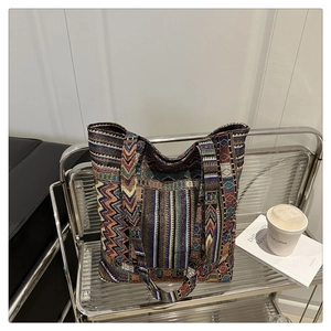Detailed macro shot of bohemian tote bag featuring colorful geometric woven patterns