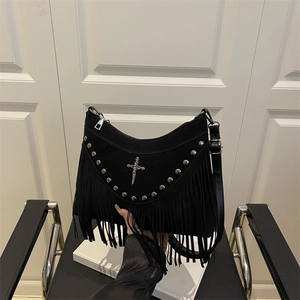 Black suede shoulder bag with long fringes, silver rivets, and a vintage cross pendant