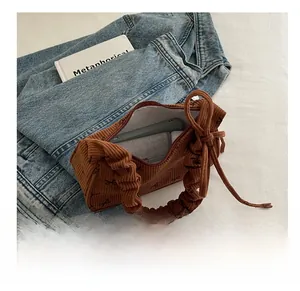 Interior view showing the large storage capacity of a brown corduroy bow handbag