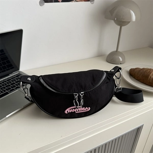 Fashionable black crescent shoulder bag with pink embroidery on an aesthetic desktop