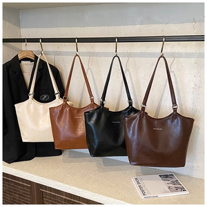 Selection of four high-capacity faux leather tote bags in cream, brown, black, and coffee