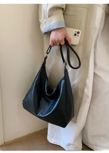 Detail shot of the black PU leather hobo bag showing texture and wide shoulder strap