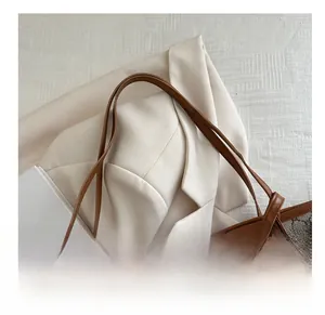 Close-up of the elegant slim brown leather shoulder strap on a monogram tote bag