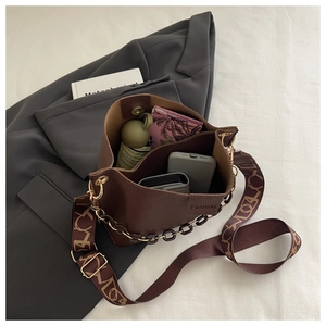 Deep brown bucket bag with lychee texture showing spacious interior for essentials