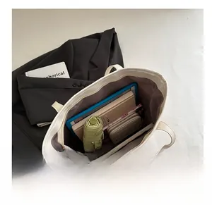 Interior view of white large capacity tote bag showing umbrella, wallet and gadgets