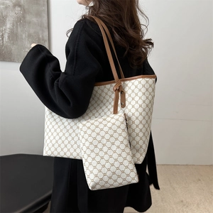 Close-up of a large tote bag with matching pouch featuring brown geometric patterns