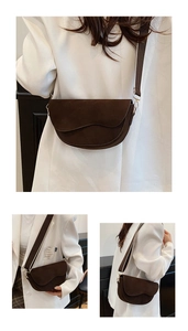 Detail of brown suede saddle bag with wavy flap design and striped fabric wide strap