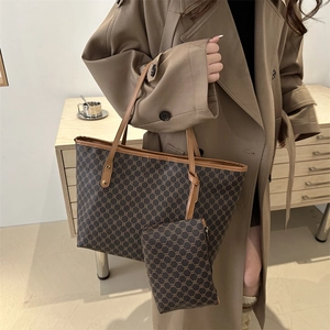 Classic monogram tote bag set with matching pouch and brown leather handles detail