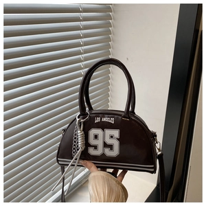 Detail of coffee brown crossbody bag with Los Angeles 95 print and silver chain tassel
