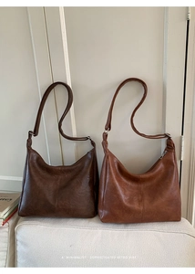 Minimalist retro hobo bags in dark coffee and caramel brown featuring soft leather texture