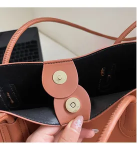 Detail of large tote bag showing double magnetic closures and premium hardware finish