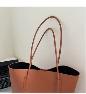 Detail of caramel tote bag with durable fine stitching and long shoulder straps