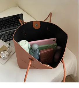 Top-down view of spacious tote bag showing interior capacity for tablet and umbrella