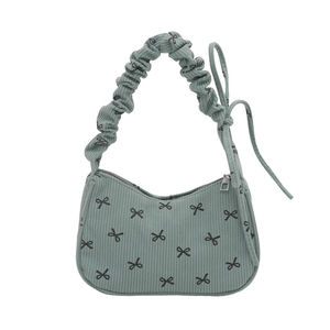 Green corduroy hobo bag with black bow patterns and ruffled handle for women
