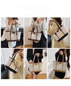 Vue détaillée du grand sac cabas en toile avec garniture en cuir porté par un mannequin