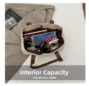 Detailed view of spacious canvas tote interior holding a tablet and daily essentials
