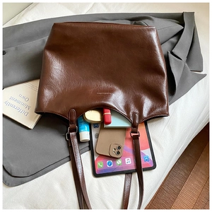 Deep brown large capacity tote bag showing interior storage for iPad and makeup