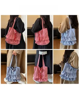 Detailed view of ruffle edges on checkered tote bag in red and blue plaid patterns