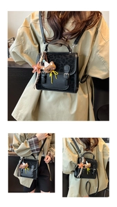 Detail of vintage leopard print flap on mini backpack with cute bear charm and buckles