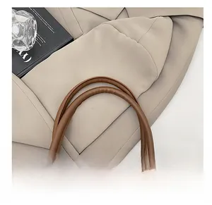 Detail of soft leopard print tote bag featuring smooth brown PU leather top handles