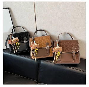 Detailed view of leopard print backpacks in black, dark brown, and light brown colors