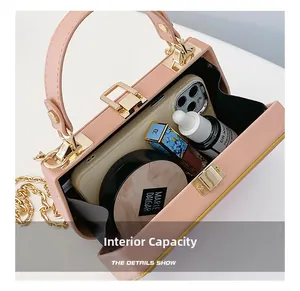 Pink chain box bag interior capacity showing phone, makeup, and daily essentials