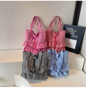 Detail view of colorful gingham tote bags with ruffle trim and drawstring closures