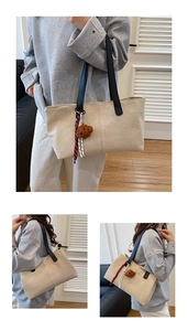 Detailed view of canvas tote bag featuring brown teddy bear charm and striped ribbon detail