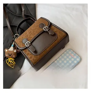 Close-up of leopard print texture and vintage leather buckles on the backpack