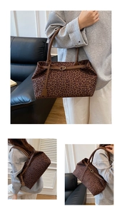 Close-up of vintage leopard print tote bag with brown leather straps and gold buckles
