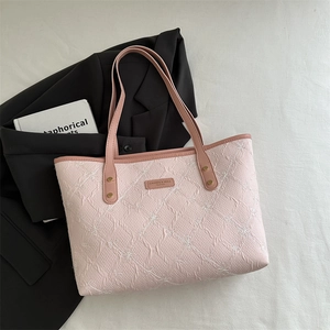 Pink underarm tote bag with white flower embroidery and minimalist shoulder strap