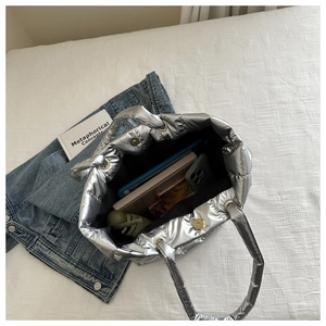 Interior detail of silver quilted tote bag showing large capacity for books and accessories