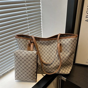 Brown monogram tote bag set with matching small zipper pouch and leather handles