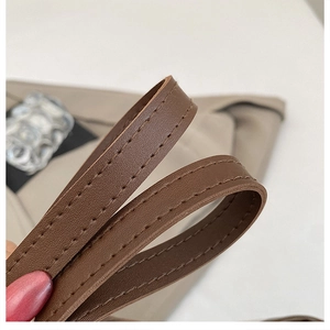 Close-up of brown PU leather shoulder strap with neat double-stitching detail