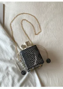 Top view of snake pattern bucket bag with pearl handle and gold chain strap