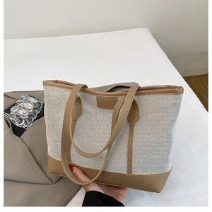 Close-up of contrast stitching and mixed fabric textures on the canvas tote bag