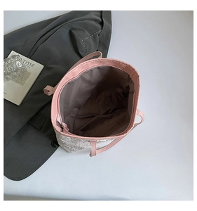 Macro detail of spacious pink tote bag interior and quilted textured white exterior