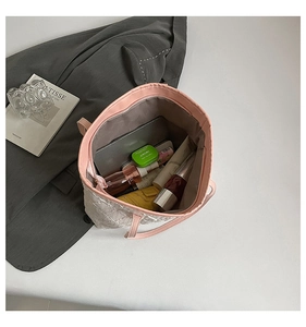 Top view of spacious interior of pink quilted tote bag showing storage for daily essentials
