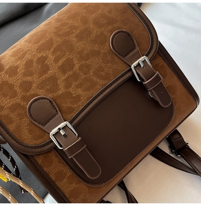 Detail view of vintage brown leopard texture bag with PU leather straps and silver buckles