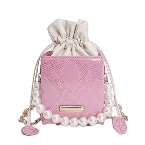 Pink snakeskin faux leather bucket bag with elegant pearl handle and gold chain strap