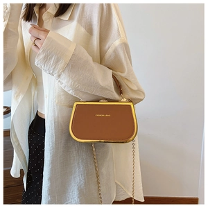 Detail of retro brown crossbody bag with gold metal frame and chain strap