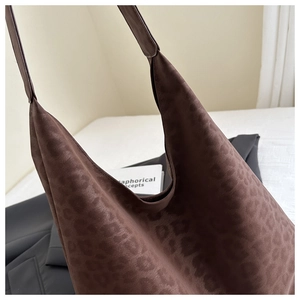 Detail of dark brown leopard print tote bag with soft suede texture and large capacity