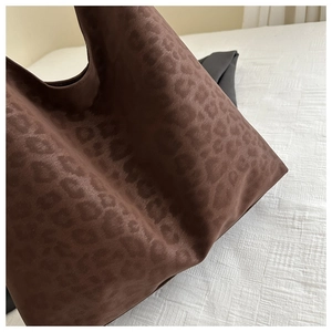 Close-up of leopard print hobo tote bag featuring soft velvet texture and large capacity